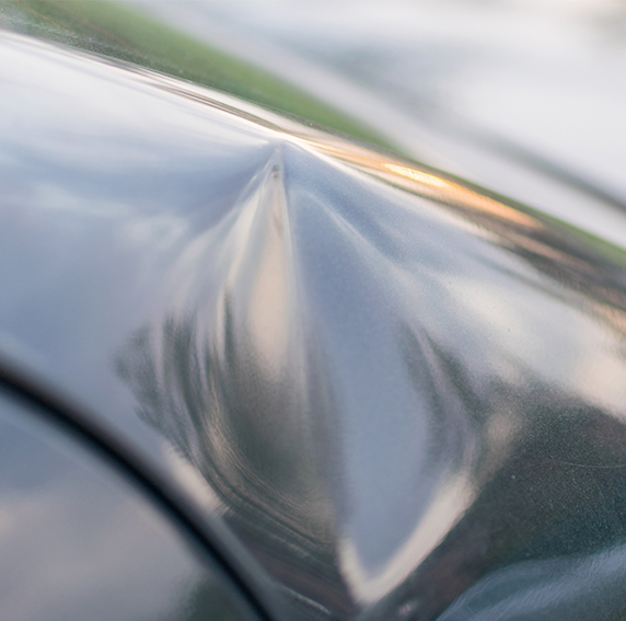 Car with dent in auto shop