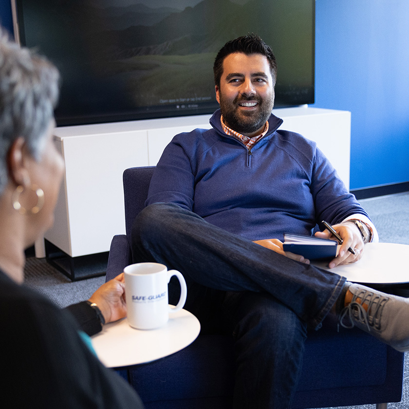 Lawrence Faretti is a happy Safe-Guard employee, engaging in a conversation with a colleague